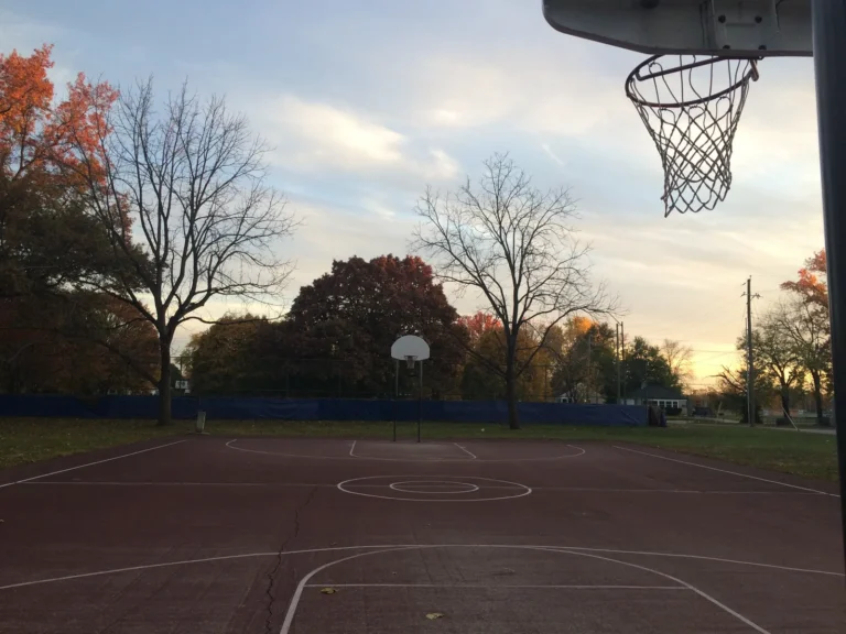Outdoor basketball court at Arsenal Park, Indianapolis, at sunset